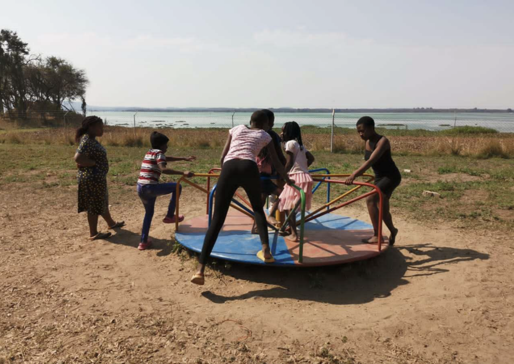 Children playing by the lake shore